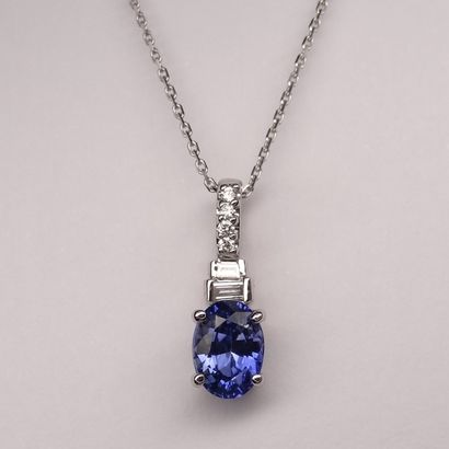 null 18k white gold pendant with a 1ct oval sapphire and two baguette cut diamonds....
