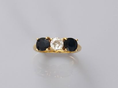 null 18k yellow gold trilogy ring surmounted by a round diamond of 0.60cts approximately...