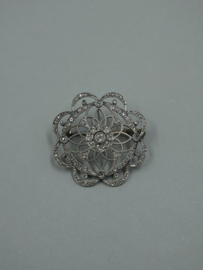 null A 14k white gold openwork rosette brooch with a central brilliant-cut diamond...