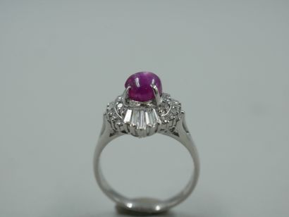 null A platinum skirt ring set with a star ruby cabochon weighing approximately 2.50cts...