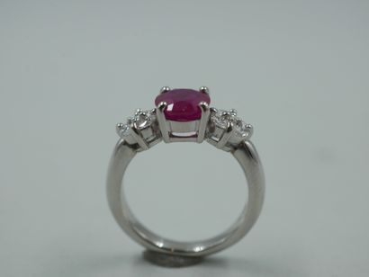 null Platinum ring centered on a ruby of 1.70 cts approximately accosted by motifs...