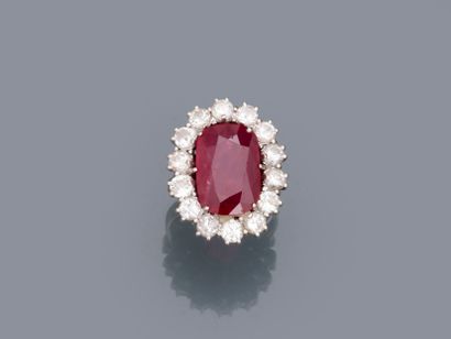 null An 18k white gold pompadour ring set with an oval ruby of about 5cts in a setting...