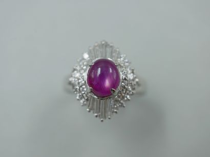 A platinum skirt ring set with a star ruby...