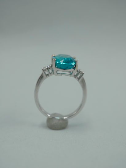 null An 18K white gold ring set with a 3.96ct natural oval apatite and diamonds....