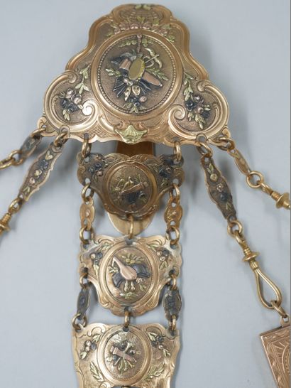 null Three gold chatelaine with chased decorations of quivers, masks, musical instruments...