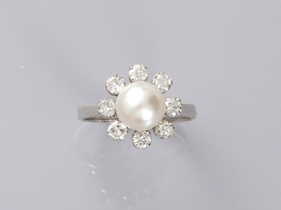 null 18k white gold flower ring set with a cultured pearl, the petals stylized by...