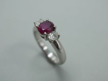 null 
Platinum trilogy ring set with a round ruby of about 1ct and two oval diamonds...