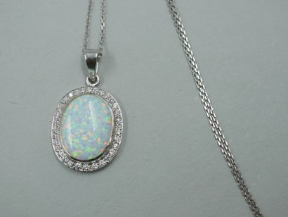 null White gold pendant set with an Australian opal in a diamond setting. With its...