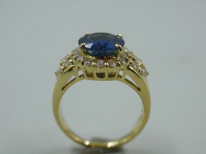 null An 18k yellow gold ring set with a 3ct sapphire in a brilliant-cut diamond setting....