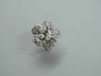 null 
A 14k yellow gold and silver flower ring centered on an emerald and paved with...