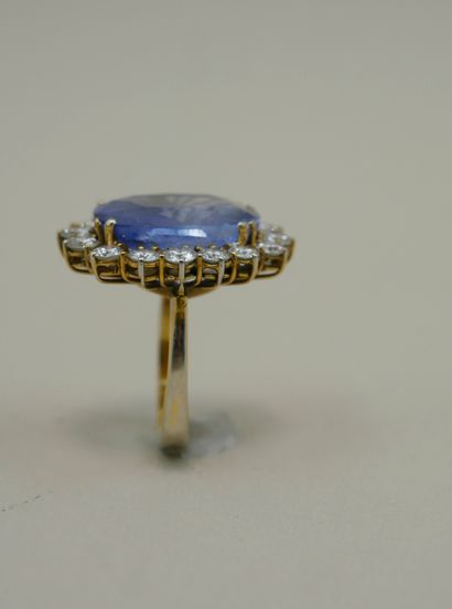 null An 18k white and yellow gold pompadour ring set with a large clear sapphire...