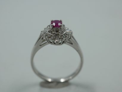 null 
An 18k white gold flower ring set with a 0.30ct natural oval ruby in a setting...