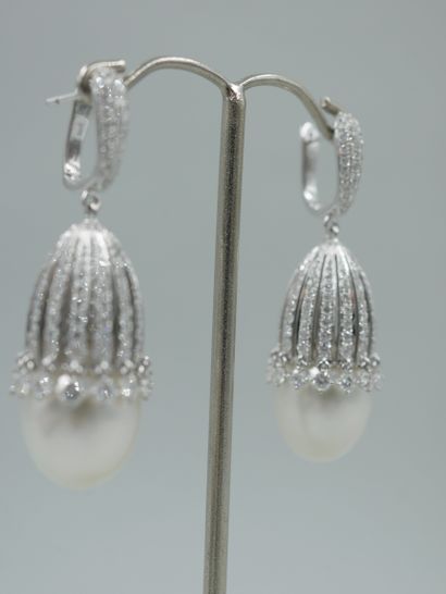 null A pair of 18k white gold earrings each composed of a large cultured pearl set...