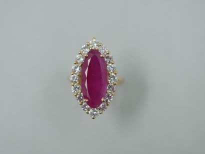 null A yellow gold marquise ring centered on a 5.05 ct ruby in a surround of diamonds...