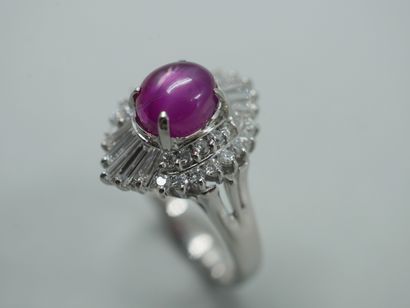 null A platinum skirt ring set with a star ruby cabochon weighing approximately 2.50cts...