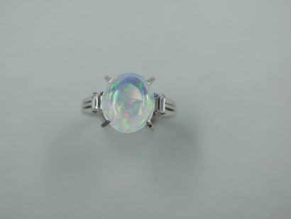 An 18k white gold ring set with an opal cabochon...
