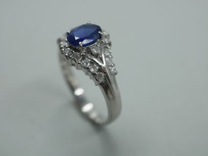 null Platinum ring with a triangular pattern set with a sapphire in a diamond setting....