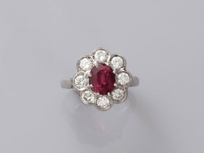 null 18k white gold daisy ring centered with a ruby weighing 1.50 to 2 cts, surrounded...