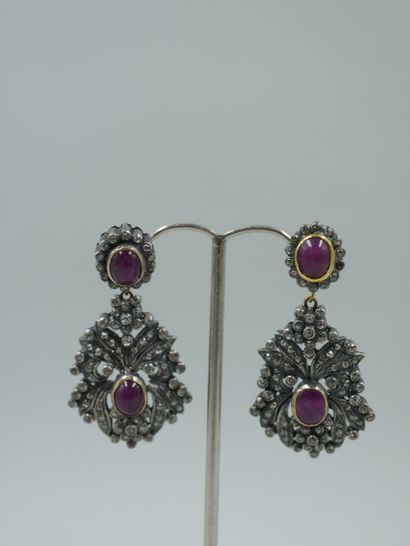 null A pair of 18k yellow gold and silver earrings with foliage and two ruby cabochons,...