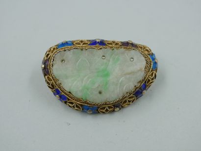 null A vermeil brooch set with a jade plate carved with flowers in an openwork enamelled...