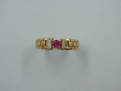 null 18k yellow gold ring, in the Cartier style, topped by a round ruby and two lines...