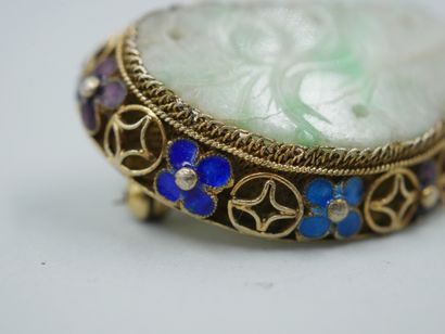 null A vermeil brooch set with a jade plate carved with flowers in an openwork enamelled...