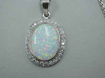 null White gold pendant set with an Australian opal in a diamond setting. With its...