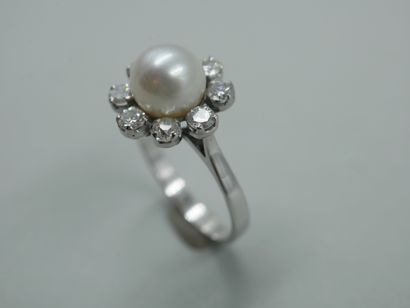 null 18k white gold flower ring set with a cultured pearl, the petals stylized by...