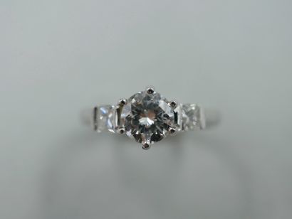 null Bague solitaire en or gris 18k ornée d'un diamant 0,75cts épaulé de deux diamants...