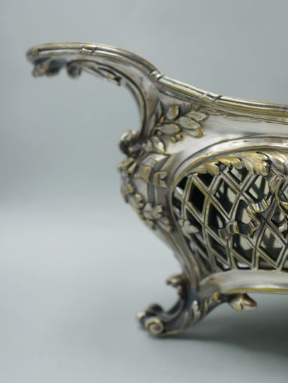 null A silvered bronze openwork planter with four blind cartouches in a frame of...