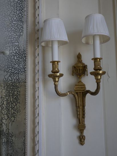 null A pair of ormolu sconces in the Louis XVI style with two arms of light, the...