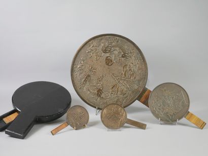 null JAPAN.

Bronze mirror decorated with storks and ideograms in a landscape. Handle...