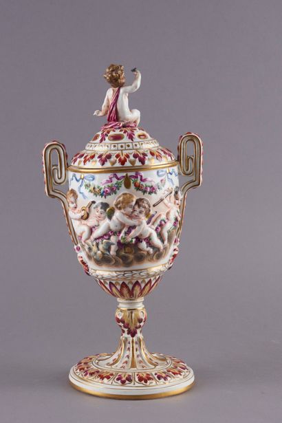 null Attributed to CAPODIMONTE.

A polychrome porcelain covered vase with bas-relief...
