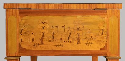 null A veneer chest of drawers inlaid with country scenes and landscapes with villages,...