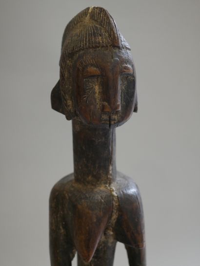 null BAMBARA, Mali. Wooden statue representing a standing female figure, arms along...
