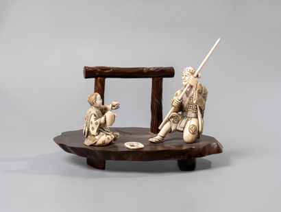 null JAPAN, 20th century.

Composition involving two figures on a wooden base: an...