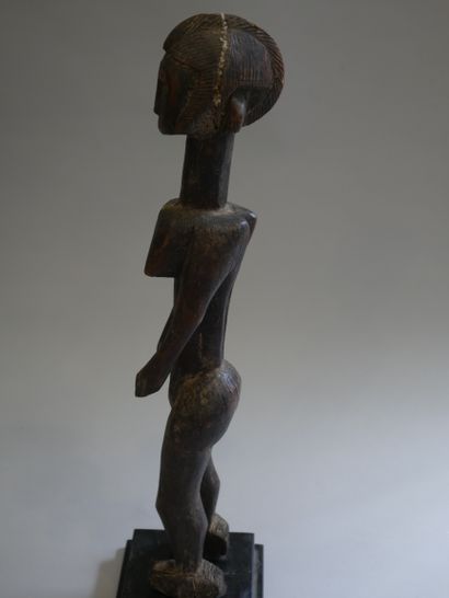 null BAMBARA, Mali. Wooden statue representing a standing female figure, arms along...