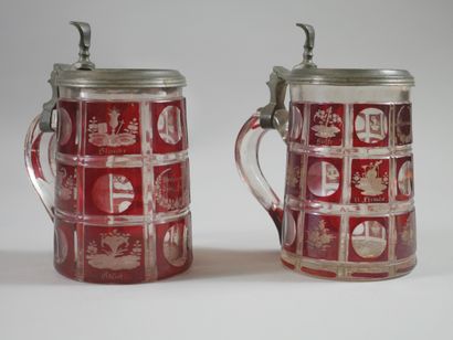 null Two red Bohemian crystal mugs decorated with floral and musical compositions....