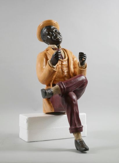 null Polychrome plaster subject representing a man with a hat, sitting, reading his...