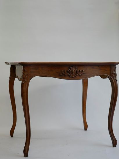 null Moulded and carved natural wood game table opening to a folding top, resting...