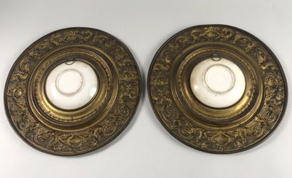 null Pair of circular dishes in repoussé metal decorated with chimeras centered on...
