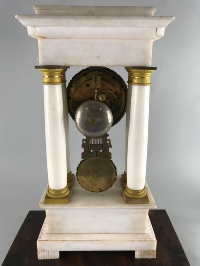 null 
Portico clock in white marble and gilt bronze decorated with scrolls and palmettes,...