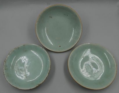 null CHINA, 18th century. 

Three celadon enamelled stoneware bowls. Marks on the...