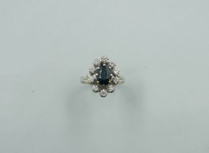 null Marquise ring in 18k white gold, centered on a doublet sapphire surrounded by...