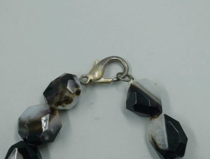 null Two necklaces, one in faceted agate beads, the other in black glass beads adorned...