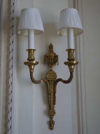 null Pair of Louis XVI style sconces in gilt bronze with two arms of light, the shaft...