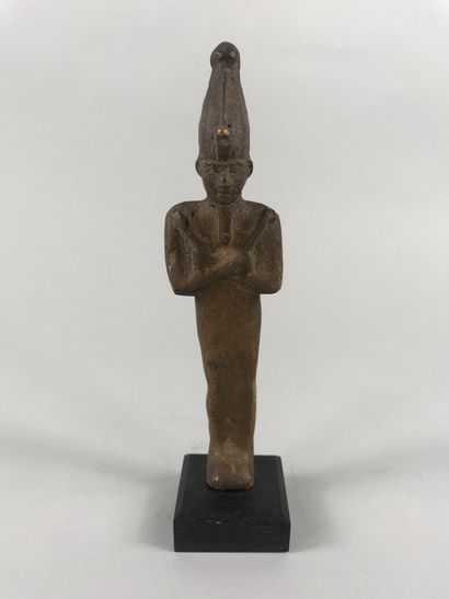 null God Osiris wearing the mitre and holding his attributes, the whip and the hoe....