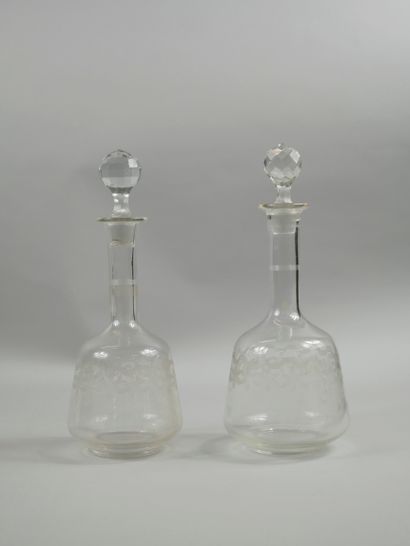null Set of two glass carafes engraved with flowers. Glass stoppers cut in diamond...