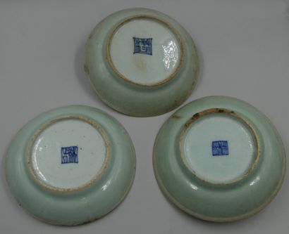 null CHINA, 18th century. 

Three celadon enamelled stoneware bowls. Marks on the...