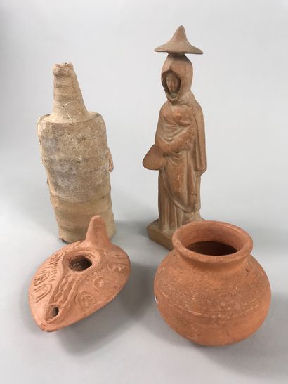 null Lot including various antique terracottas of which an oil lamp and a woman wearing...